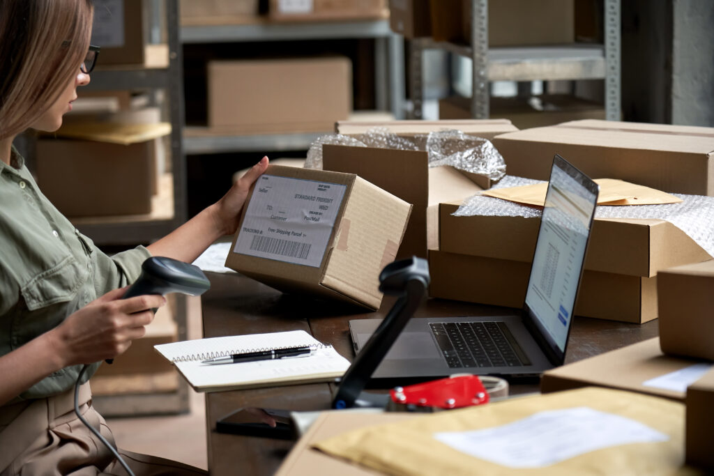female seller scanning ecommerce shipping box in d 2025 02 11 16 20 49 utc