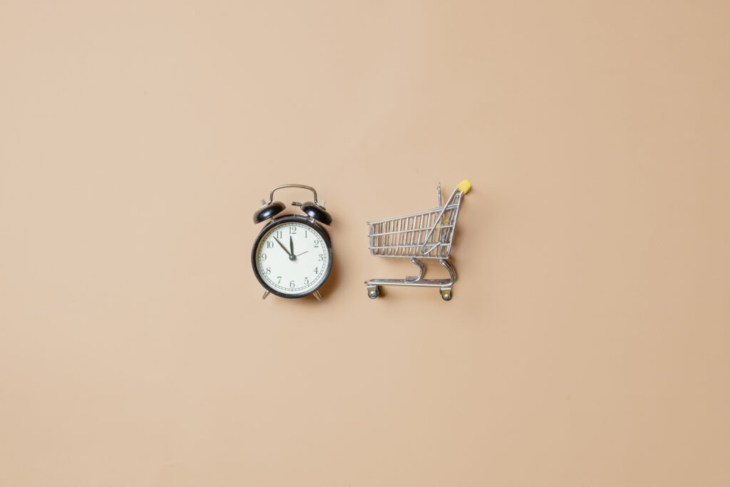 metal little shopping cart and black alarm clock 2024 09 25 06 01 49 utc