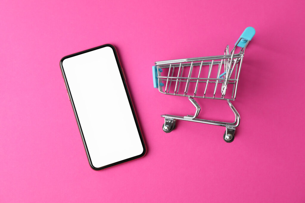 phone with empty screen and shopping cart on pink 2025 03 26 21 12 29 utc