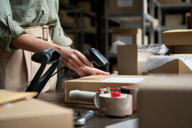 female seller scanning ecommerce shipping box in d 2025 02 11 16 16 04 utc