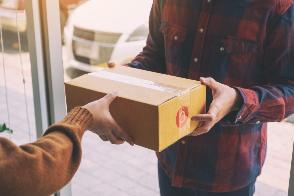 E-Ticarette İade Oranları Nasıl Düşürülür? 5 woman receiving parcel box from delivery man at th 2026 01 07 05 53 24 utc